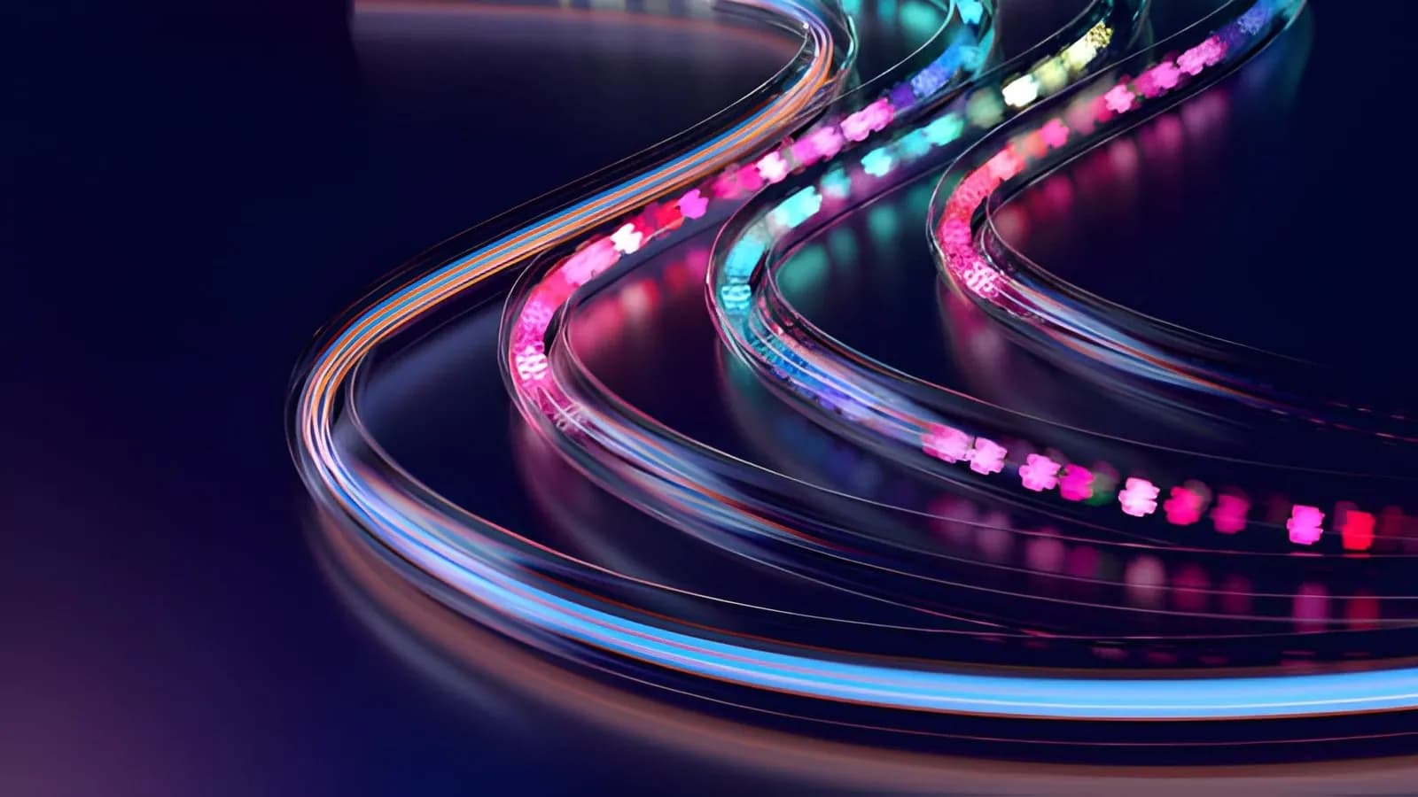 Glowing multicolored fiber-optic light trails curving through the dark